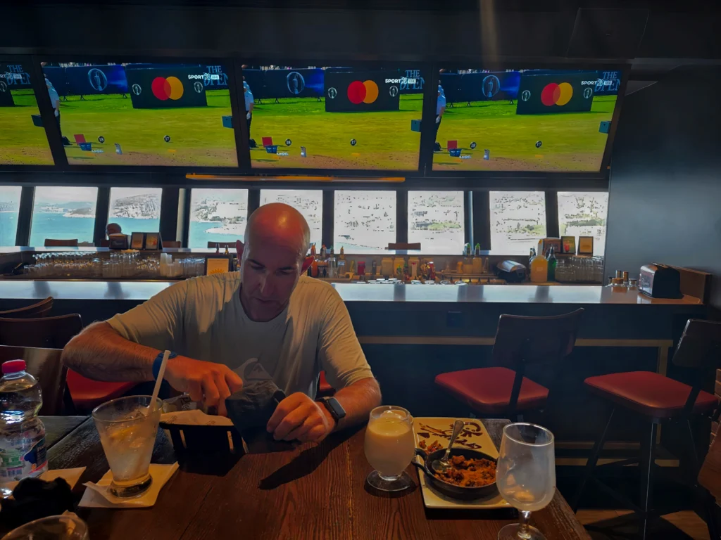 A young guest enjoying wings at Playmakers Sports Bar on Odyssey of the Seas