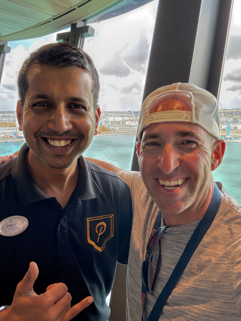 Playmakers bartender Dinesh with a young guest on Odyssey of the Seas