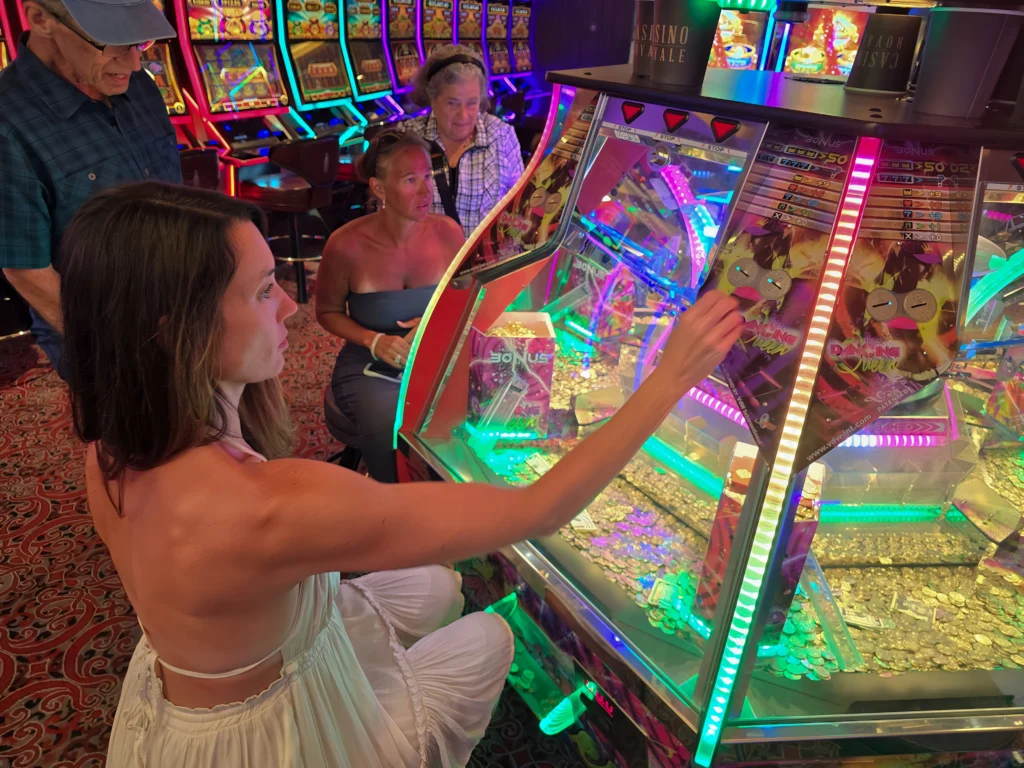 Playing the quarter pusher arcade game in Casino Royale on Odyssey of the Seas