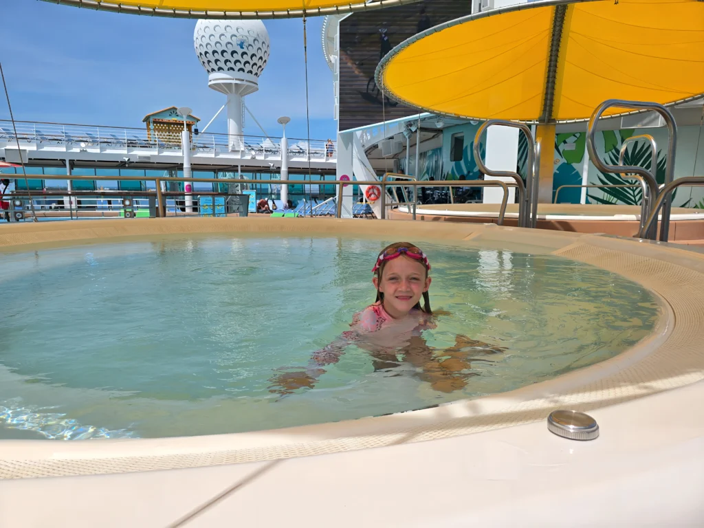 A child in a pool deck hot tub on Freedom of the Seas