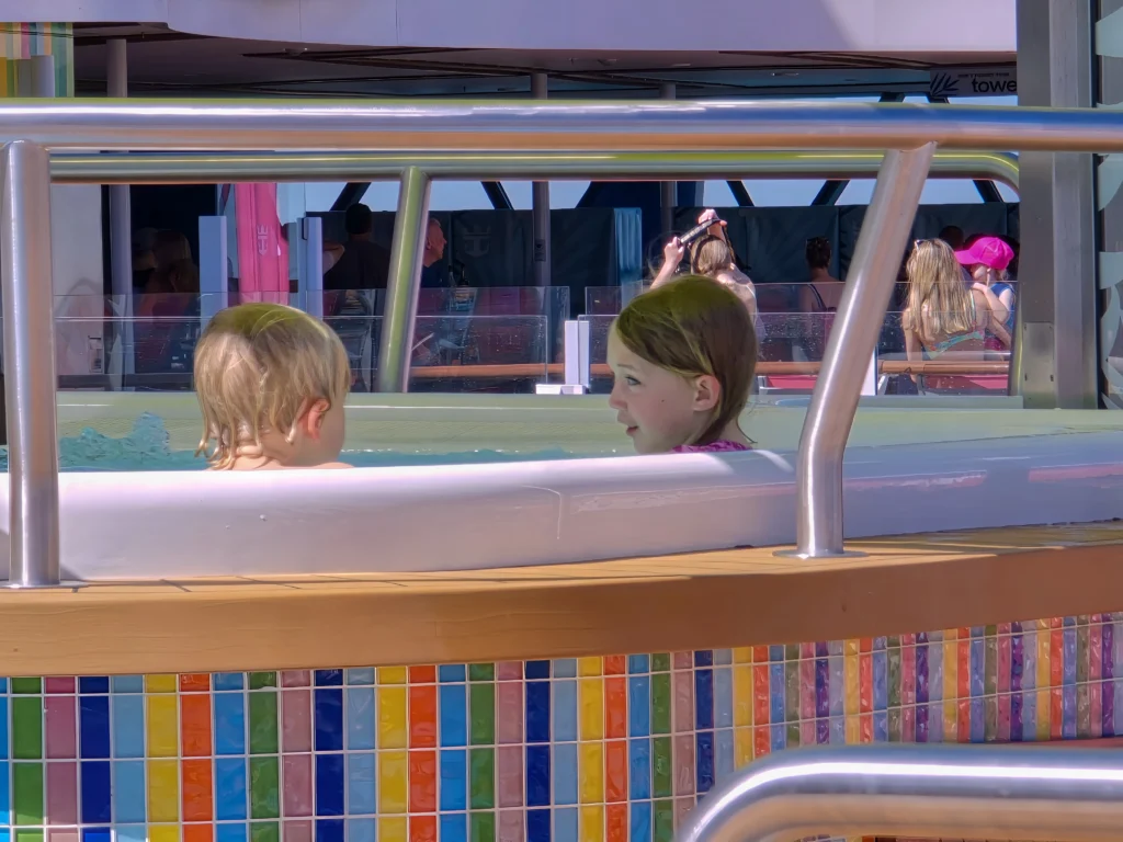 My daughter in a hot tub by the beach pool on Utopia of the Seas