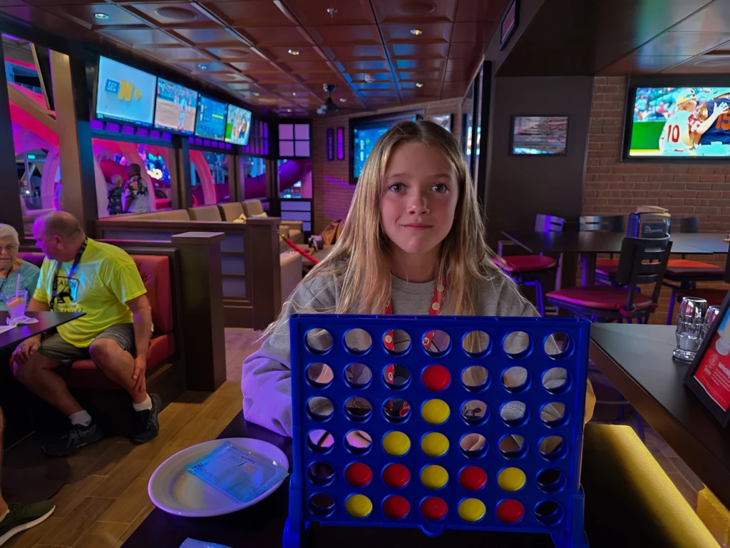 Playing oversized Connect Four at Playmakers Sports Bar on Utopia of the Seas